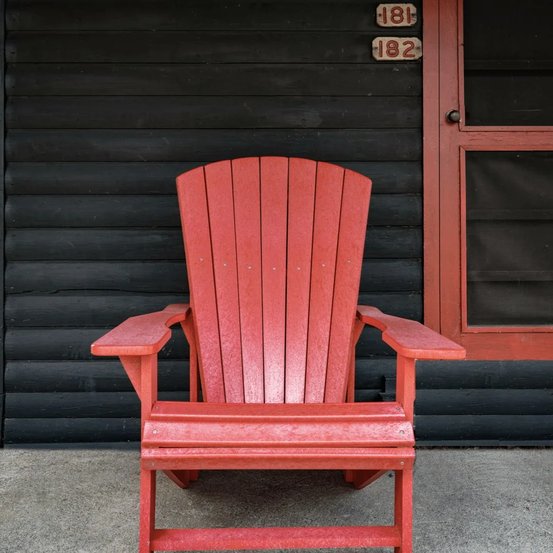 Red Adirondack chair outside Woodside Cabin at Killarney Mountain Lodge