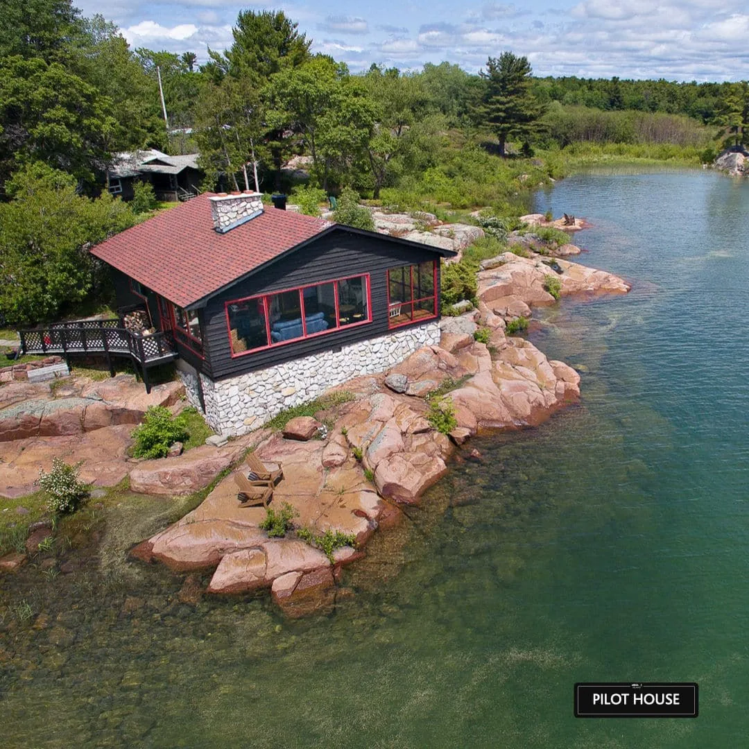 Aerial view of the Pilot House beside Killarney Channel in the green season at Killarney Mountain Lodge