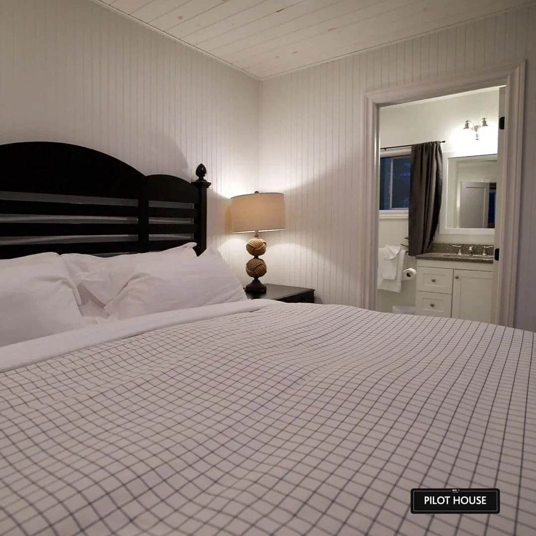 Pilot House bedroom with a dark wood headboard at Killarney Mountain Lodge