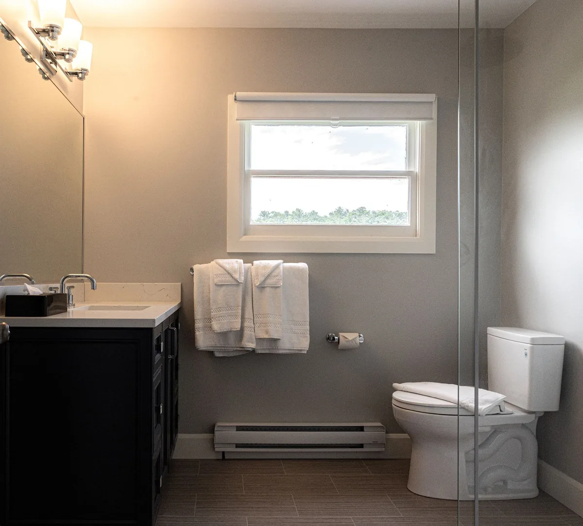 Historic East House bathroom with towels and a window at Killarney Mountain Lodge