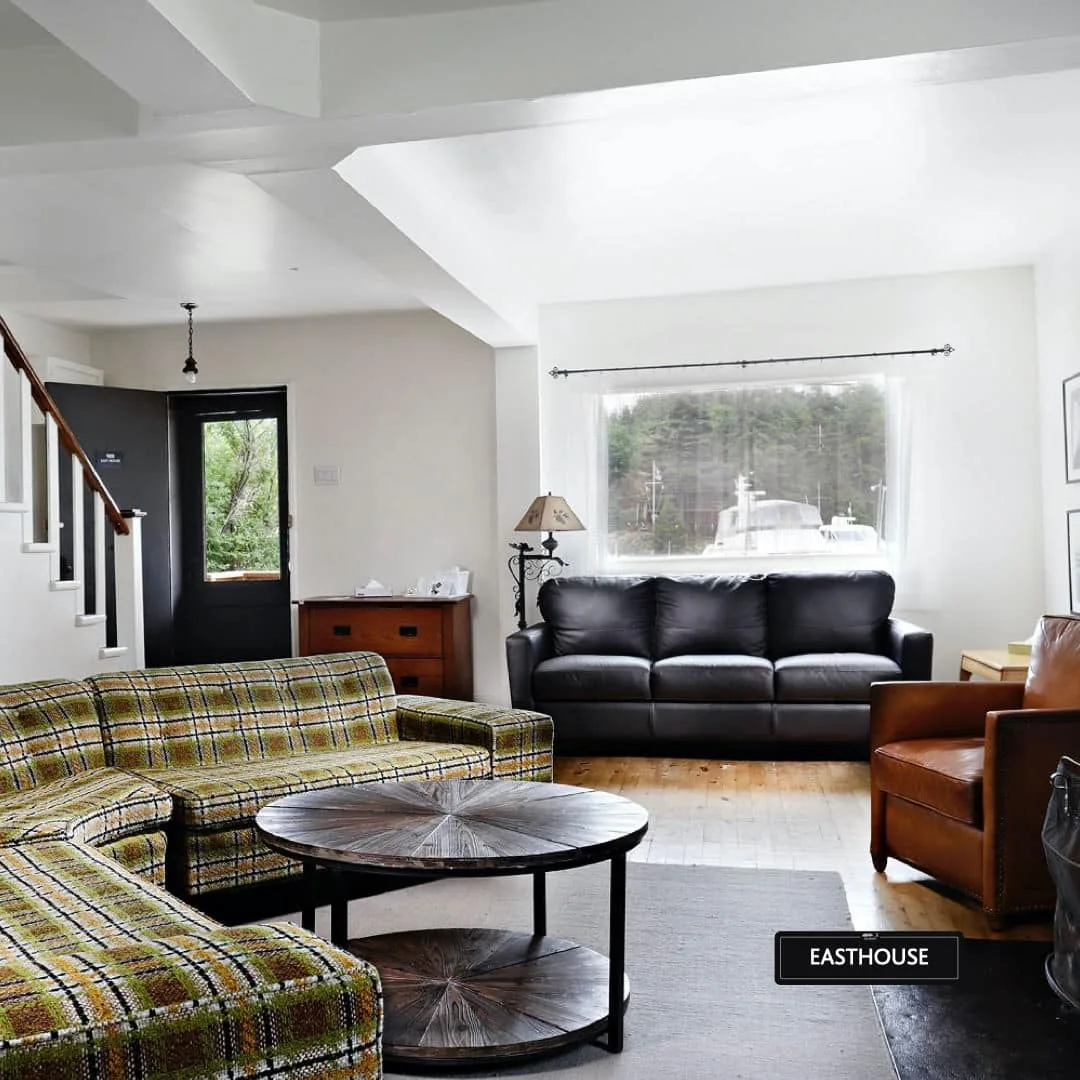 Historic East House living room with seating and a staircase at Killarney Mountain Lodge