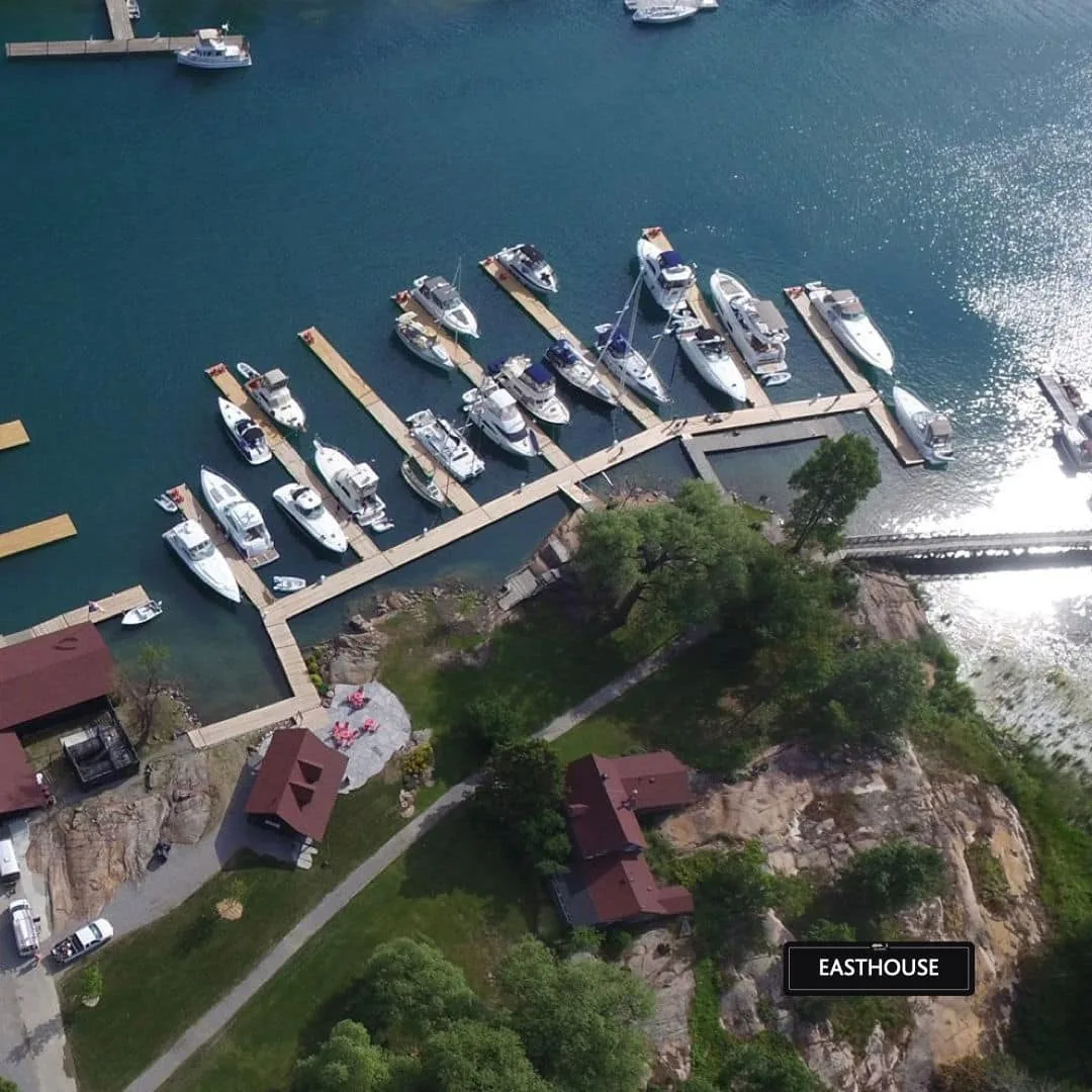 Aerial view of Historic East House and the nearby marina in the green season at Killarney Mountain Lodge