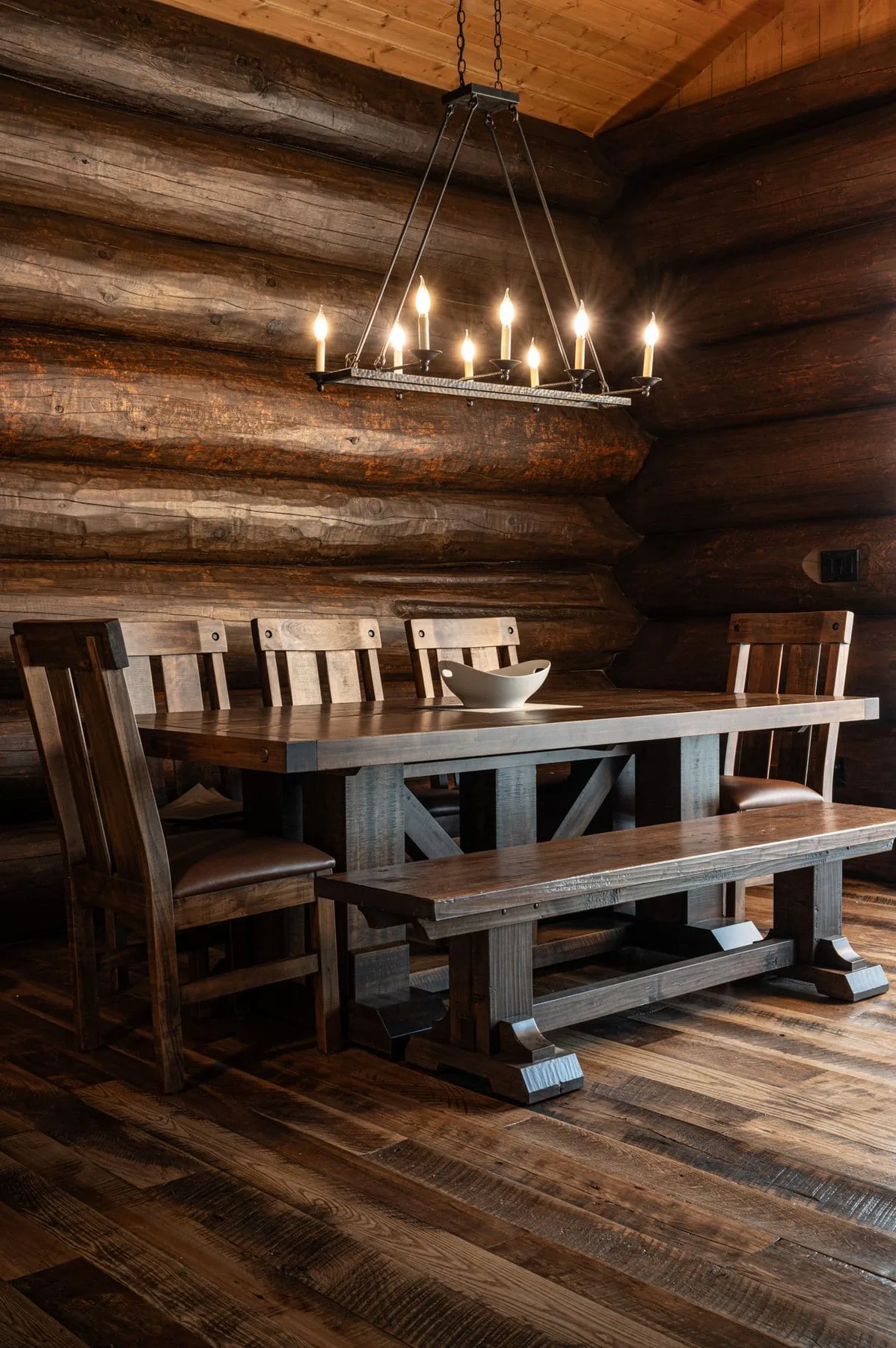 Dining area beneath a chandelier inside a log cabin at Killarney Mountain Lodge