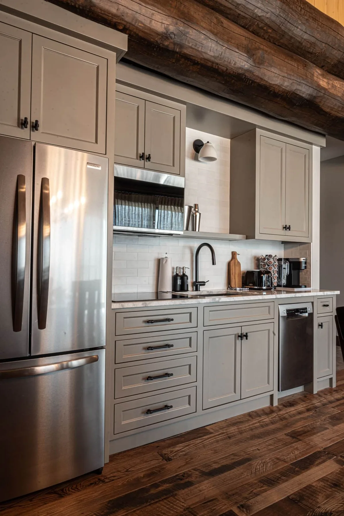 Light cabinetry and appliances in a log-cabin kitchenette at Killarney Mountain Lodge