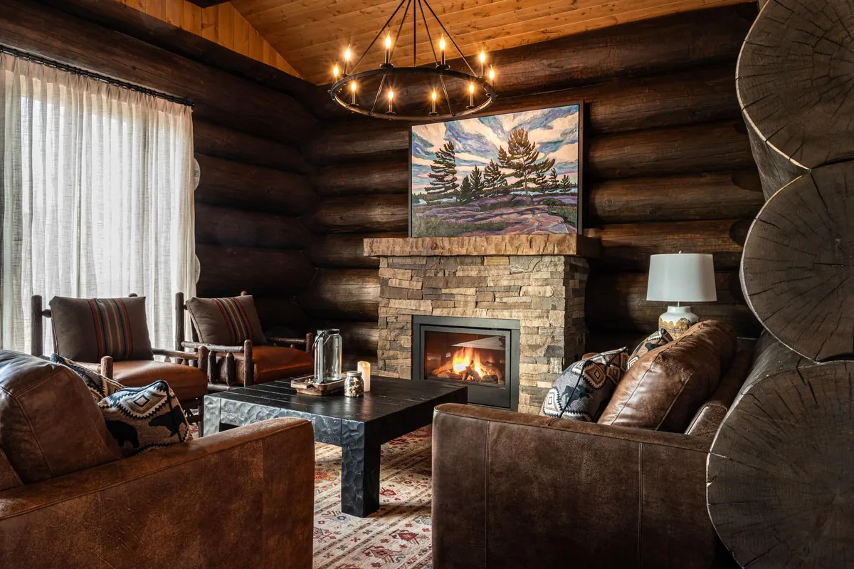 Log-cabin seating area beside a stone fireplace at Killarney Mountain Lodge