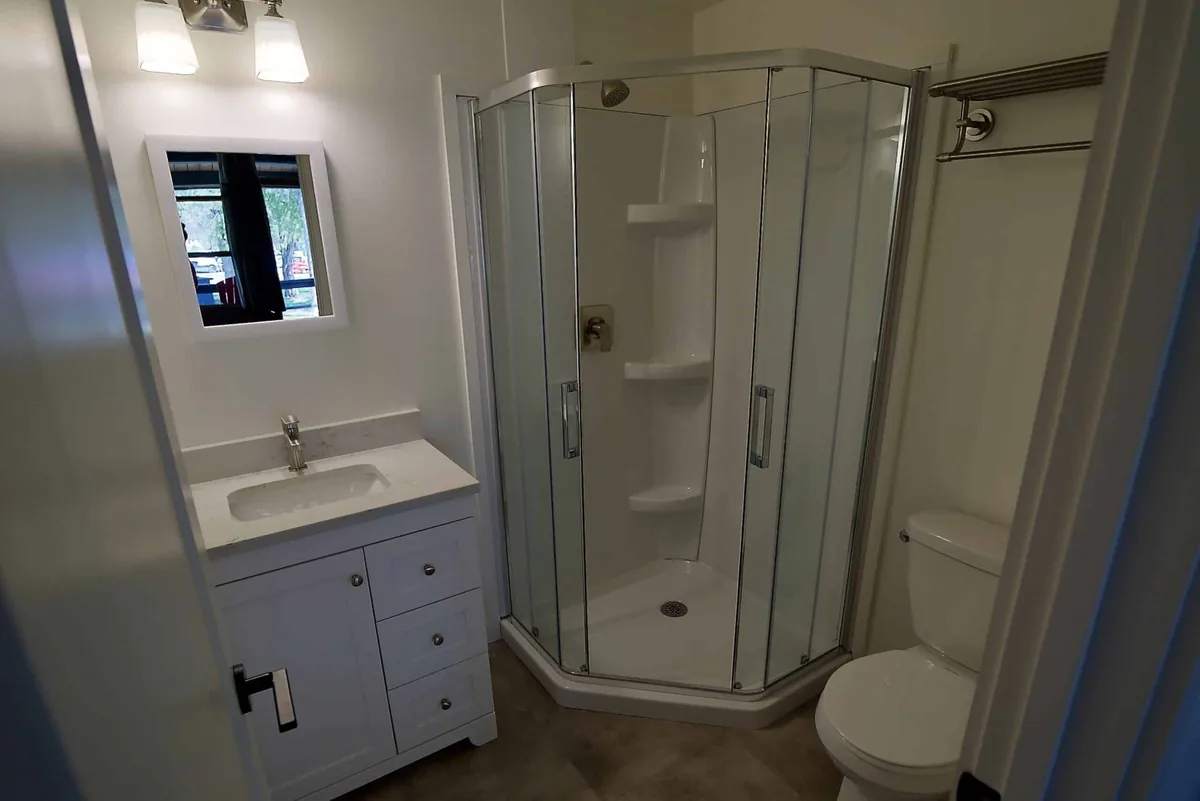 Pine Lodge bathroom with a shower and white vanity at Killarney Mountain Lodge
