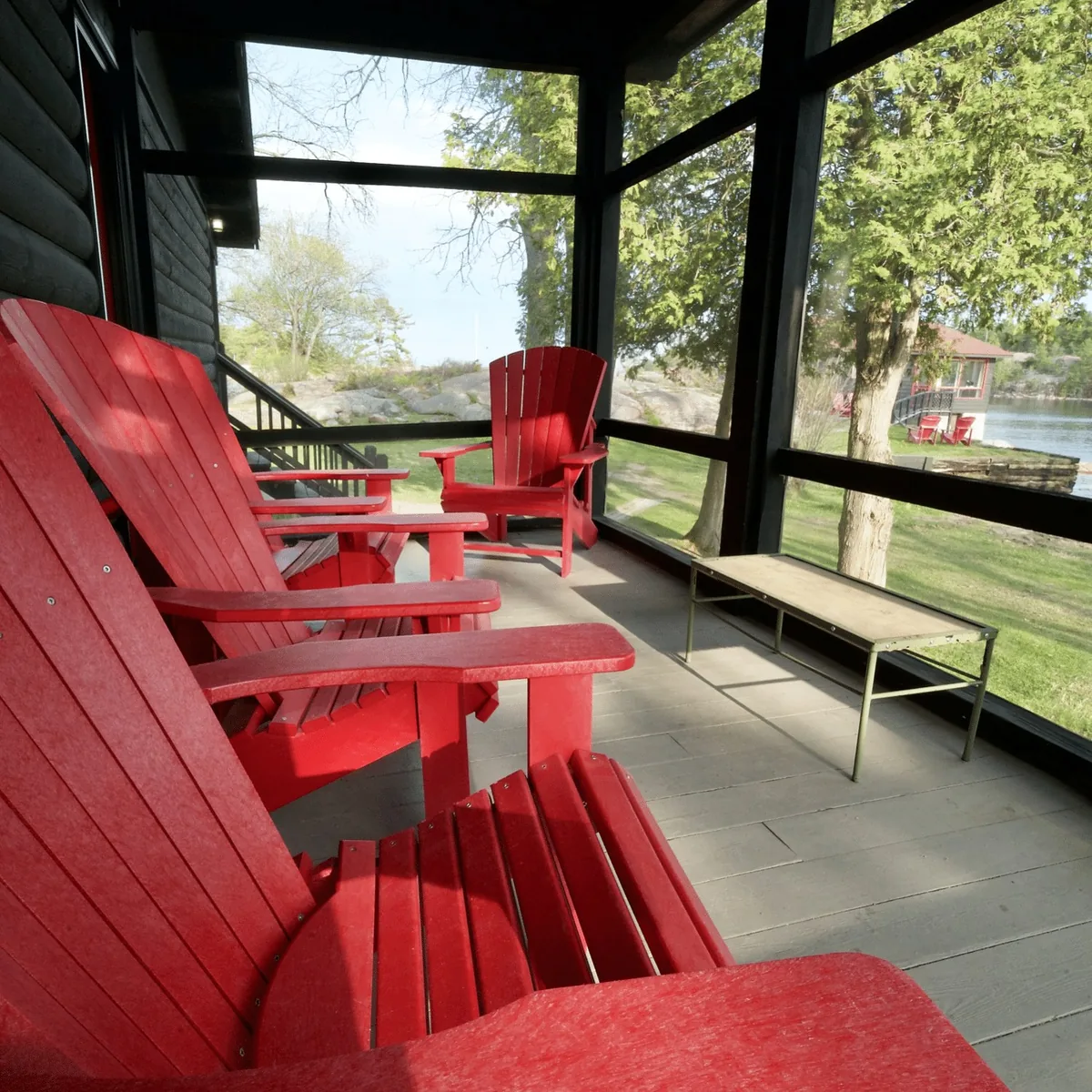 Porch Suite screened porch with red Adirondack chairs at Killarney Mountain Lodge