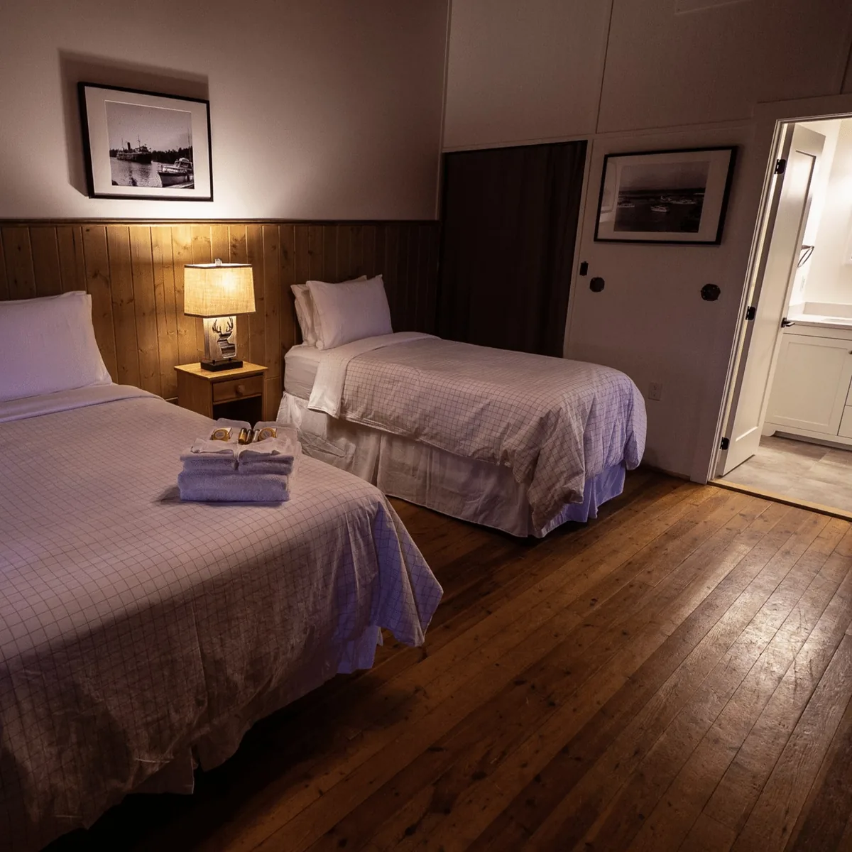 Porch Suite bedroom with two beds and a bathroom doorway at Killarney Mountain Lodge
