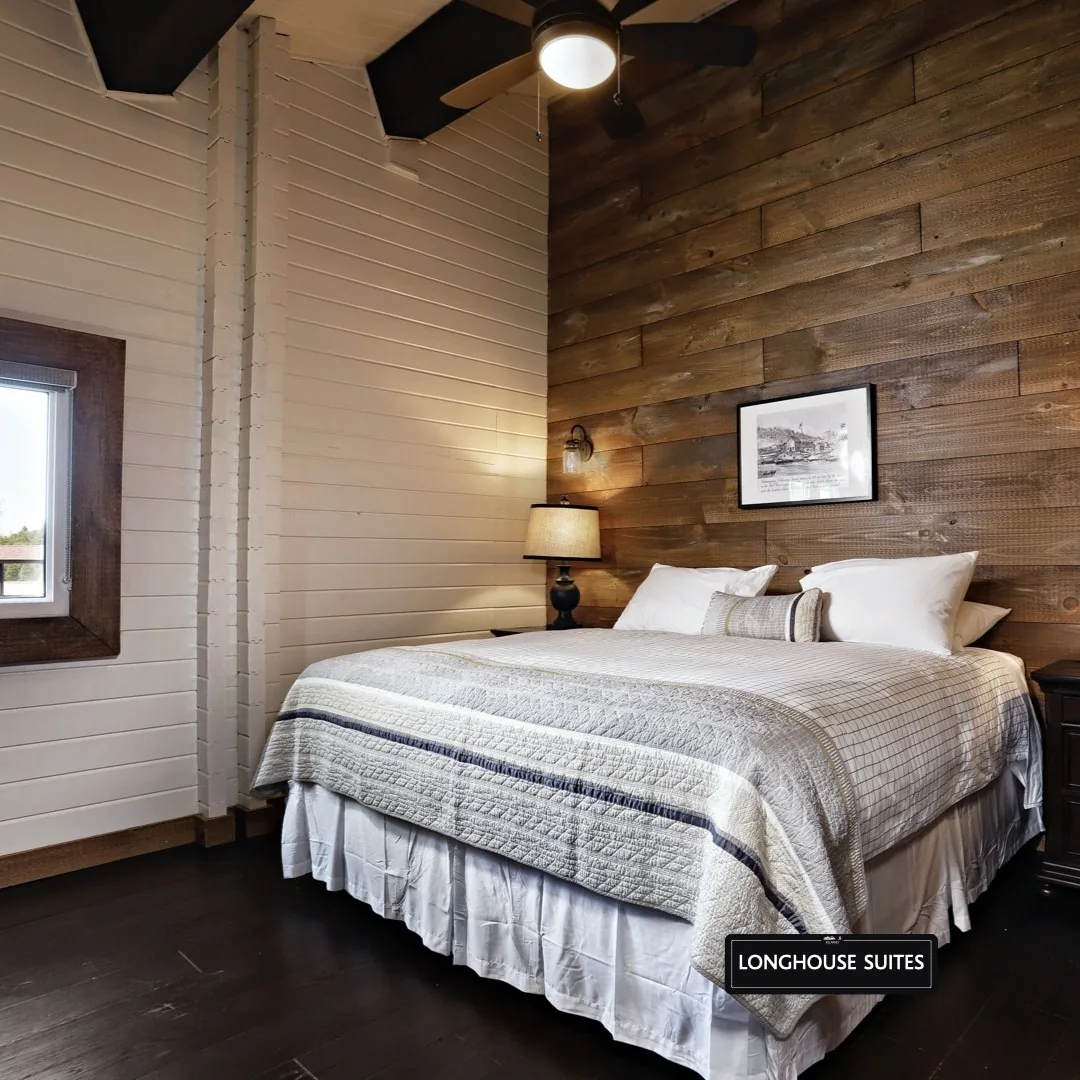 Long House Suite bedroom with a wood feature wall at Killarney Mountain Lodge