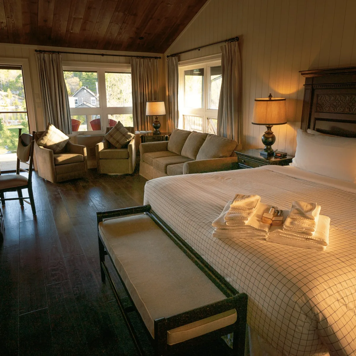 King View Suite bed and sitting area beside large windows at Killarney Mountain Lodge