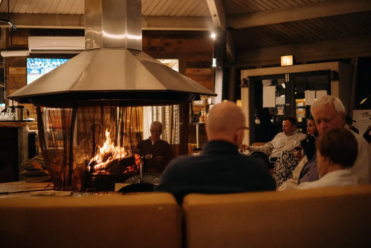 Guests gathered around the central fireplace in the Carousel Lounge.